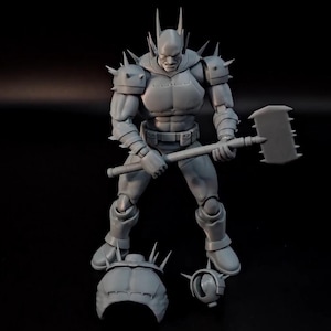 May include: A grey unpainted action figure of a muscular character with spiked shoulder armour and a headpiece with tall spikes. The figure holds a large rectangular hammer with a serrated edge. Two additional head pieces are placed at the feet.