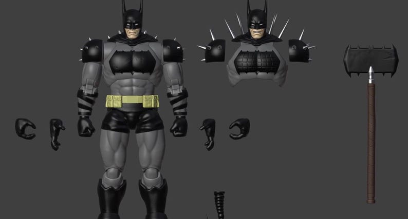 May include: A grey and black action figure of a caped character with a yellow utility belt, featuring interchangeable parts including an alternate torso with spikes, extra hands, and a large black hammer with a brown handle on a dark background.