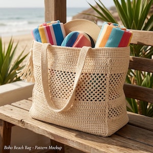 May include: A beige crochet tote bag featuring a central open-weave diamond pattern, two sturdy handles, and a side tassel. Inside the bag are two rolled beach towels with colorful stripes and a wide-brimmed straw hat. Text reads: Boho Beach Bag - Pattern Mockup.