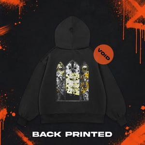 May include: A black hooded sweatshirt featuring a back graphic of three stained-glass window panels. The central panel displays the text "Thy Kingdom Come 8:1" with a fleur-de-lis. The side panels show skeletal figures and cross motifs.