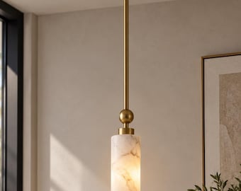 May include: A cylindrical pendant light fixture featuring a white marble shade with grey veining. The fixture has a brass-toned metal rod, a circular ceiling canopy, and a spherical accent piece connecting the rod to the marble cylinder.