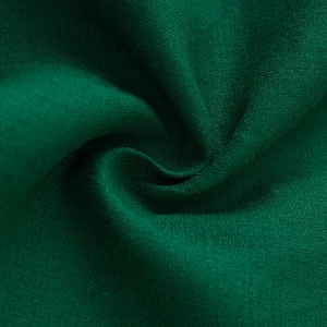 May include: A deep forest green fabric with a visible woven texture. The material is gathered in the center, creating soft, flowing folds and shadows that highlight the consistent, solid color and the natural weave of the textile surface.