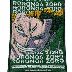 May include: Embroidered patch featuring a character illustration with the text "RORONOA ZORO" in white on a green background. The patch has a rectangular shape with a green border and a detailed design.