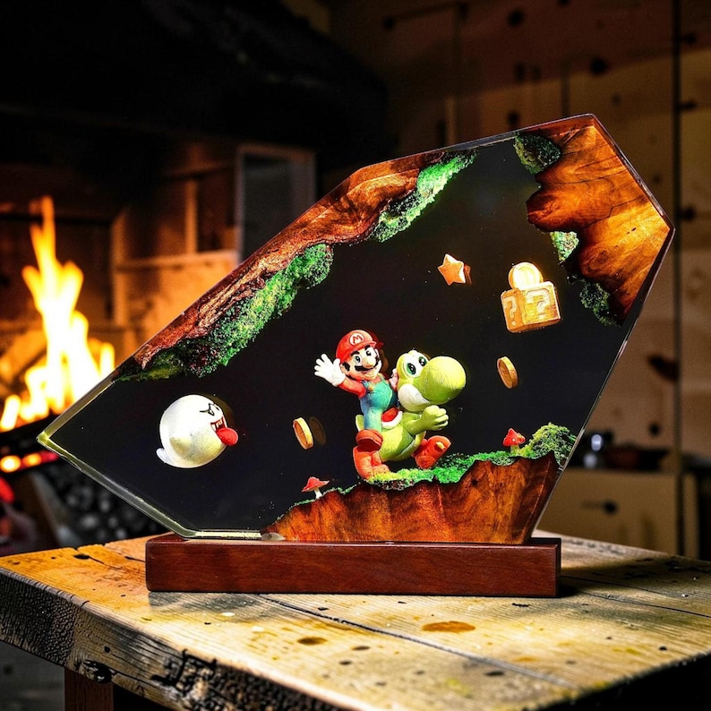May include: A decorative resin and wood display featuring Mario riding Yoshi, a Boo ghost, a question mark block, and floating coins. The scene is encased in a dark, polished resin slab with natural wood edges and green moss accents on a base.
