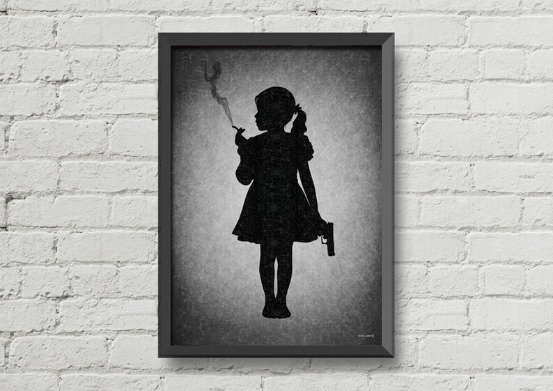 May include: Black and white framed print of a silhouette of a girl holding a cigarette and a gun. The background is a textured gray.