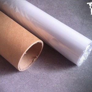 May include: A brown cardboard tube with a white plastic tube inside. The plastic tube is wrapped in clear plastic and has a label that says "Total Lost".