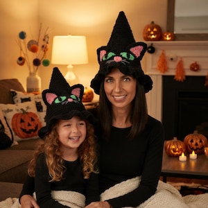 Peut inclure: Deux chapeaux noirs au crochet en forme de chat avec des sommets pointus de chapeau de sorcière. Chaque chapeau présente des yeux brodés vert vif, des oreilles intérieures roses et un petit nez rose avec des moustaches. Bords larges et volantés.