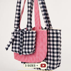 May include: Three tote bags in varying sizes featuring a gingham check pattern in black and white or red and white. The bags have long shoulder straps and a small matching drawstring pouch. Text on the image reads 3 SIZES + BONUS DRAWSTRING POUCH.