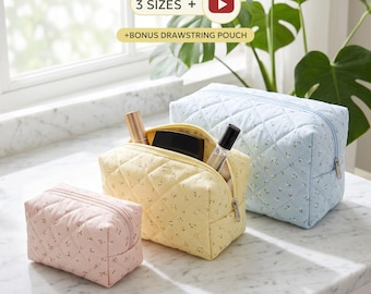 May include: Three quilted cosmetic bags in light pink, yellow, and light blue, each featuring a small floral pattern and a zipper closure. The yellow bag contains two small bottles. Text on the image reads 3 SIZES + BONUS DRAWSTRING POUCH.