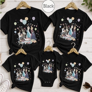 Op de afbeelding: Een set van vijf zwarte t-shirts en &eacute;&eacute;n zwarte romper met een grafische print van personages uit Frozen, waaronder Elsa, Anna, Olaf en Sven. Het ontwerp bevat ballonnen, een verjaardagstaart, cadeautjes en de tekst Birthday Girl.