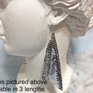 May include: Silver tone chainmail earrings, 5 inches long. Available in 3 lengths.