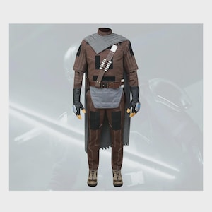 May include: A brown and gray costume set featuring a long-sleeved shirt, matching trousers, a gray cape, black gloves with blue accents, a brown utility belt with a bandolier, and a gray loincloth panel. The outfit includes tan lace-up boots.