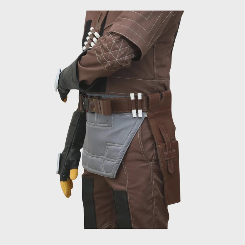 May include: A brown tactical costume suit featuring a quilted elbow patch, a dark brown utility belt with white cylindrical accents, a grey hip plate, and a brown holster. The outfit includes black gloves with yellow fingertips and silver wrist details.