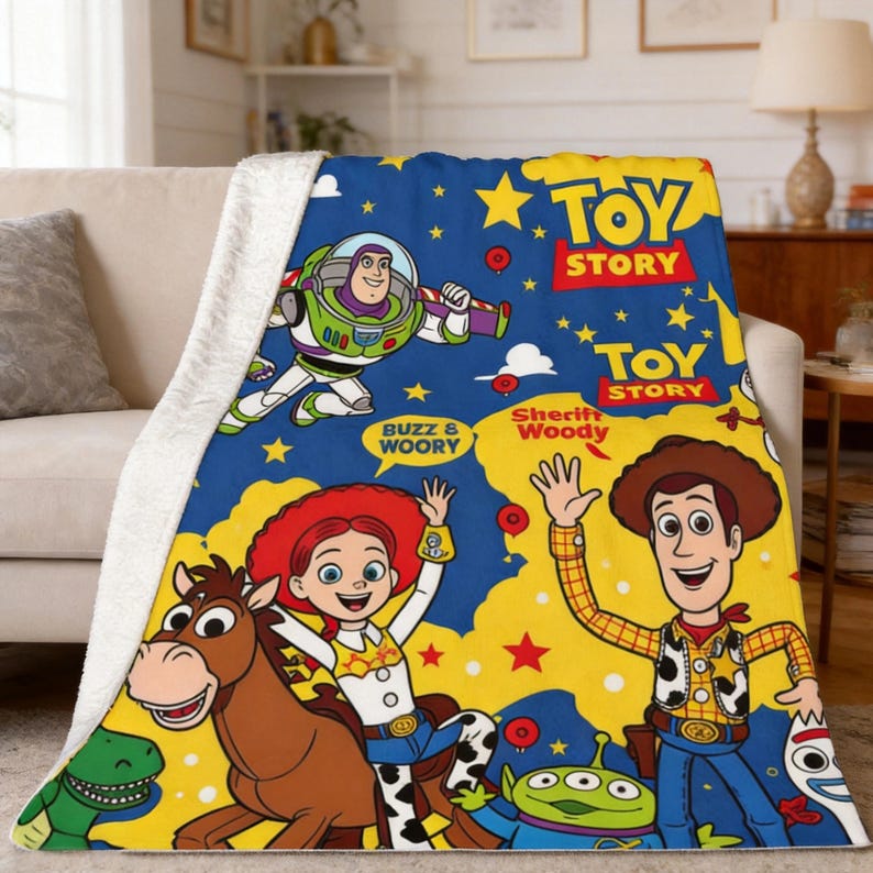 May include: A plush throw blanket featuring a vibrant blue and yellow background with Toy Story characters including Buzz Lightyear, Sheriff Woody, Jessie, Bullseye, Rex, and an alien. The text Toy Story and Sheriff Woody is printed on the fabric.
