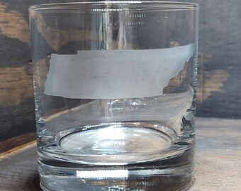 May include: A clear glass tumbler with a frosted outline of the state of Tennessee.