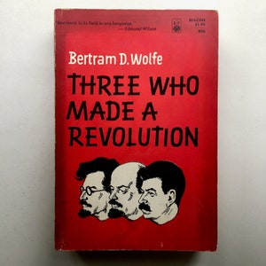 May include: A red book cover with the title "Three Who Made A Revolution" by Bertram D. Wolfe. The cover features black and white illustrations of three men's faces.
