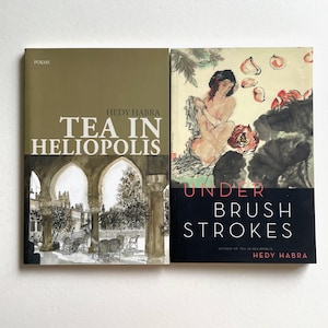 May include: Two books with the same author, Hedy Habra. The book on the left is titled "Tea in Heliopolis" and is a collection of poems. The book on the right is titled "Under Brush Strokes" and is a collection of paintings.