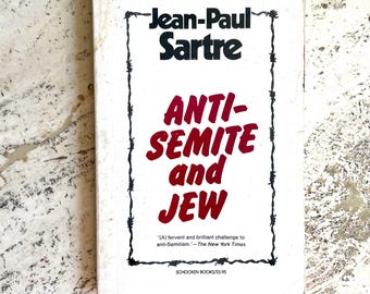 May include: A vintage paperback book titled "Anti-Semite and Jew" by Jean-Paul Sartre. The book cover is white with black text and a red title. A quote from The New York Times is included.