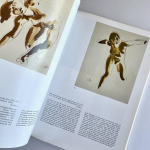 May include: Two black and white sketches of nude figures. The figures are drawn in a loose, gestural style. The sketches are on a white background.