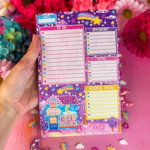 May include: A rectangular notepad with a purple starry night background featuring a shooting star, a Late Night Bookshop illustration, and sections labelled Date, To Do, Important, Notes, and Reading Things with colourful star bullet points.