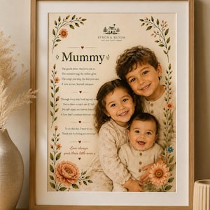 May include: A framed wall art print featuring a photograph of three children, a poem titled Mummy, and floral illustrations. The text includes Byron & Bloom Art for Cosy Homes and the poem text. The frame is light wood with a white mat border.