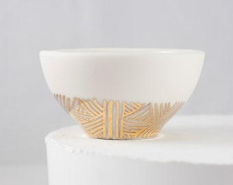 Tiny porcelain bowl with gold pattern