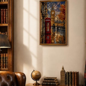 May include: A framed wall art print depicting a rainy London street scene with a red telephone booth, the Big Ben clock tower, and autumn trees. The painting features a dark, moody color palette with vibrant red and orange highlights.