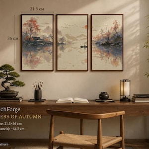 May include: A triptych wall art set titled Still Waters of Autumn by LumenStitchForge, featuring a landscape with trees, mountains, and a boat on water. Each panel measures 21.5 cm by 36 cm, with a total set width of 64.5 cm. The design is for Aida 14 count.