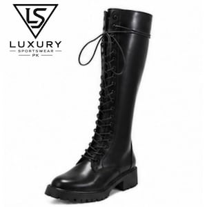 May include: A black knee-high boot with a front lace-up closure and a thick lug sole. The boot features a smooth finish and long laces tied at the top. The logo for Luxury Sportswear PK is visible in the upper left corner with a triangle icon.