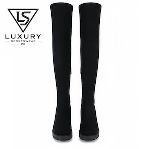 May include: A pair of black over-the-knee boots with a smooth, fitted textile upper and a thick, matching black sole. The logo LS LUXURY SPORTSWEAR PK is visible in the upper left corner, featuring a triangle icon above the brand name text.