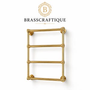 May include: A polished gold-tone metal towel rack featuring four horizontal bars and two vertical supports with decorative circular wall mounts. Above the rack, the text BRASSCRAFTIQUE is displayed beneath a circular logo containing the letter B.