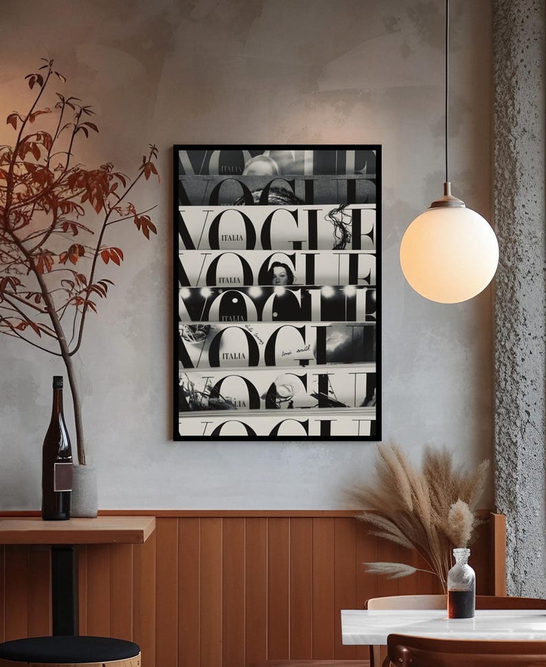 May include: A rectangular black-framed wall art print featuring a collage of multiple Vogue Italia magazine covers stacked horizontally. The artwork displays the bold black and white typography of the Vogue logo repeated across several distinct sections.
