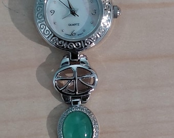 Vintage women's quartz wristwatch with silver-tone links and jade colored stones