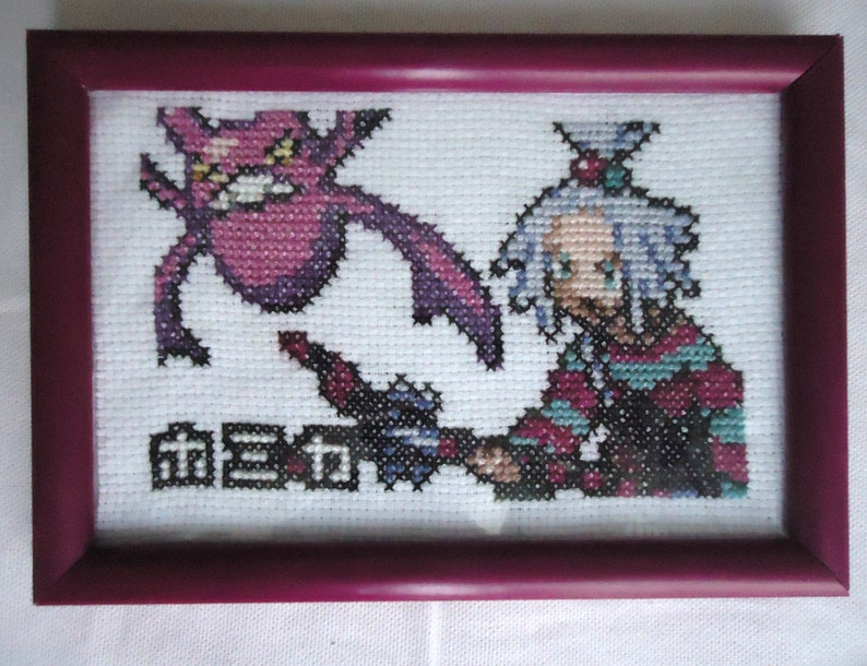 Framed cross stitched Roxie and Crobat