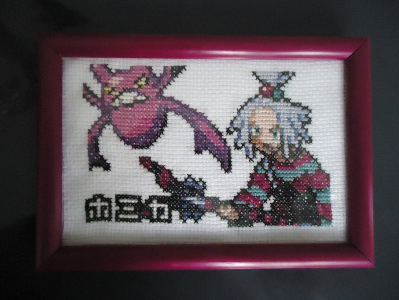Framed cross stitched Roxie and Crobat