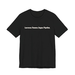 May include: Black t-shirt with the white text: Lacrosse. Finance. Segue. Pipeline. The shirt has short sleeves and a crew neck. The text is centered horizontally across the chest.