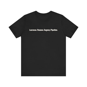 May include: Black t-shirt with the text "Lacrosse. Finance. Segway. Pipeline." in white. The shirt has short sleeves and a crew neck. The text is centered on the chest.