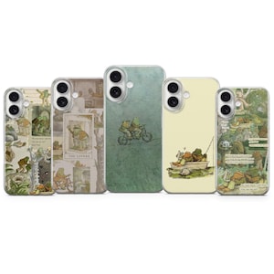 May include: Five phone cases featuring illustrations of frogs in various scenes. Designs include frogs on a tandem bicycle, fishing in a boat, a tarot card labelled THE LOVERS, and multiple vignettes with text bubbles, all rendered in muted, earthy tones.
