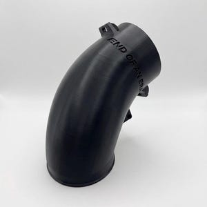 May include: A black, curved, cylindrical pipe connector featuring a 90-degree bend. The exterior surface is smooth with visible 3D printed layer lines. Embossed on the upper section of the pipe is the text "END OF AN ERA" in capital letters.