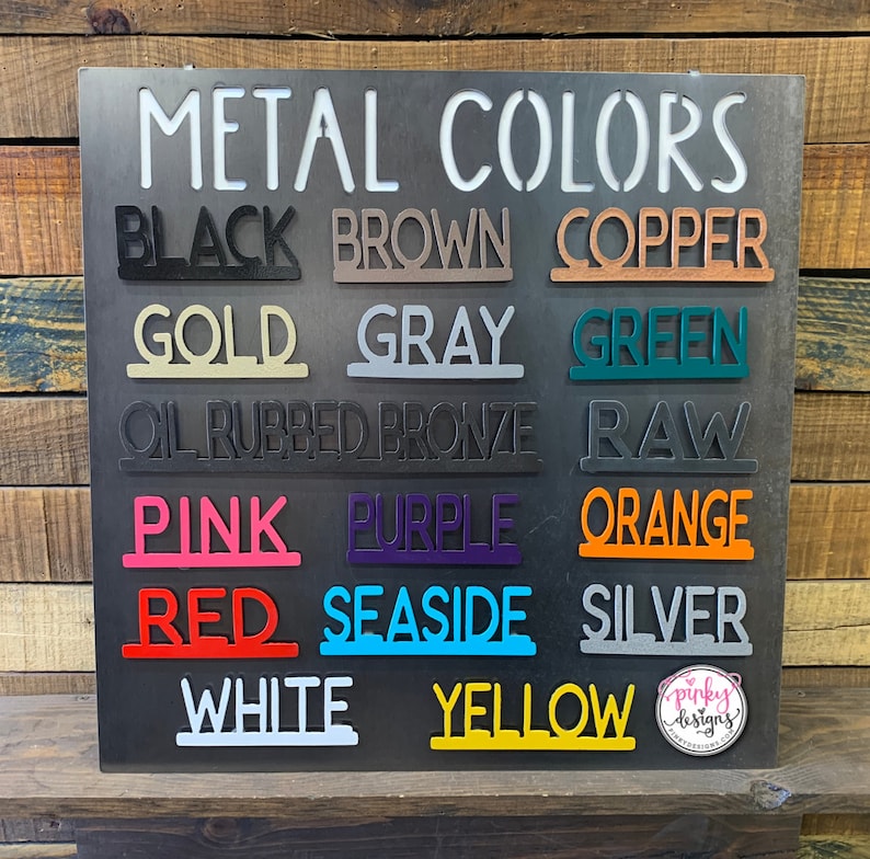 A metal display board showing various metal color options: Black, Brown, Copper, Gold, Gray, Green, Oil Rubbed Bronze, Raw, Pink, Purple, Orange, Red, Seaside, Silver, White, and Yellow.