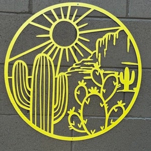 May include: Yellow metal wall art depicting a desert scene with a sun, cacti, and mountains. The art is circular and has a cutout design.