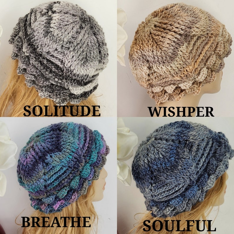 May include: Four crocheted hats in different color combinations: gray and white, brown and beige, blue and green, and blue and gray. The hats have a scalloped edge and a textured design.