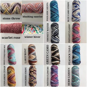 May include: A collection of sixteen skeins of yarn in various variegated colorways, each labeled with names including stone throw, blushing sunrise, poolside siesta, blue camo stripe, scarlet rose, winter hiver, smokey water, instant classic, green turquoise mix, lakefront, green camo, peacock tails, cinnamon cedar, songbird stripe, winter flowers, and herb garden.