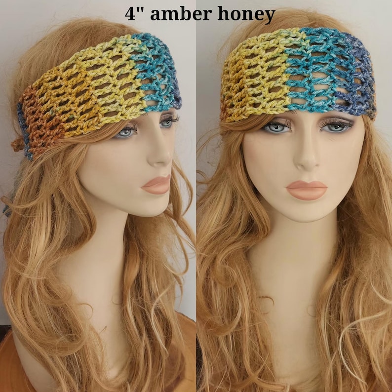 May include: A 4-inch wide crochet headband featuring a variegated color pattern of amber, yellow, and blue tones. The accessory has an open, airy stitch design and is displayed on a mannequin head with long blonde hair.