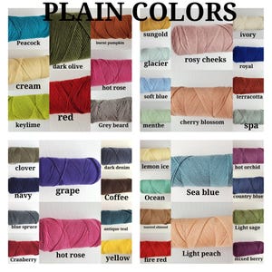 May include: A color chart titled PLAIN COLORS displaying numerous skeins of yarn in various shades including peacock, dark olive, burnt pumpkin, sungold, ivory, glacier, rosy cheeks, royal, cream, hot rose, red, grey beard, soft blue, cherry blossom, terracotta, menthe, spa, clover, grape, dark denim, navy, coffee, lemon ice, sea blue, hot orchid, blue spruce, antique teal, ocean, country blue, cranberry, hot rose, yellow, toasted almond, light peach, light sage, fire red, and mixed berry.