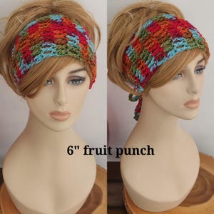 May include: A 6-inch wide crochet headband featuring a multicolored pattern of red, orange, green, and blue yarn. The accessory is displayed on a mannequin head and includes the text 6" fruit punch printed clearly on the image surface.