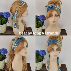 May include: A blue and beige crocheted headband with long strands hanging down the back. The headband is worn by a model with long blonde hair. The model is wearing the headband in four different ways, showing how it can be styled.