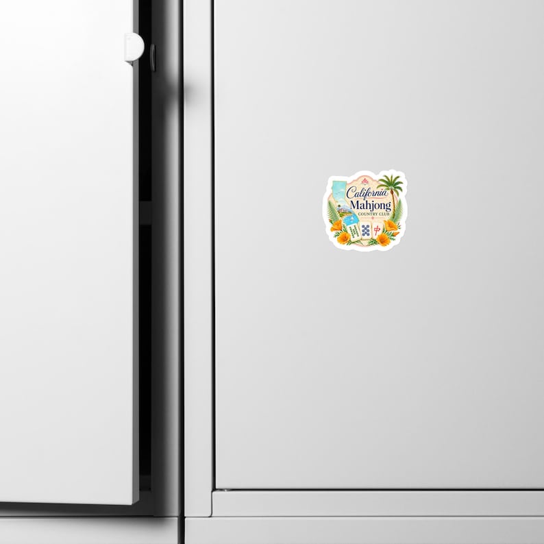 May include: A die-cut sticker featuring the text California Mahjong Country Club, a palm tree, orange poppy flowers, and three mahjong tiles. The design includes a light blue silhouette of the state of California on a white background.