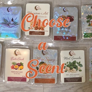 May include: An assortment of scented wax melts in clear plastic packaging. The image features various scents, including "Zest Life," "Macaron-i Art," "Coffee Cake," "Island Coconut Cream," "Forbidden Tropics," "Exotic Crush," "Main Squeeze," "Mint Ganache," and "Ruby Refresher." The text "Choose a Scent" is overlaid.