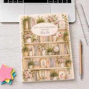 May include: A rectangular planner with a cream-coloured cover featuring a bookshelf illustration filled with books, potted plants, flowers, a globe, and a framed rainbow. The centre oval label reads Early Career Teacher Planner 2026-2027 Miss Rae.